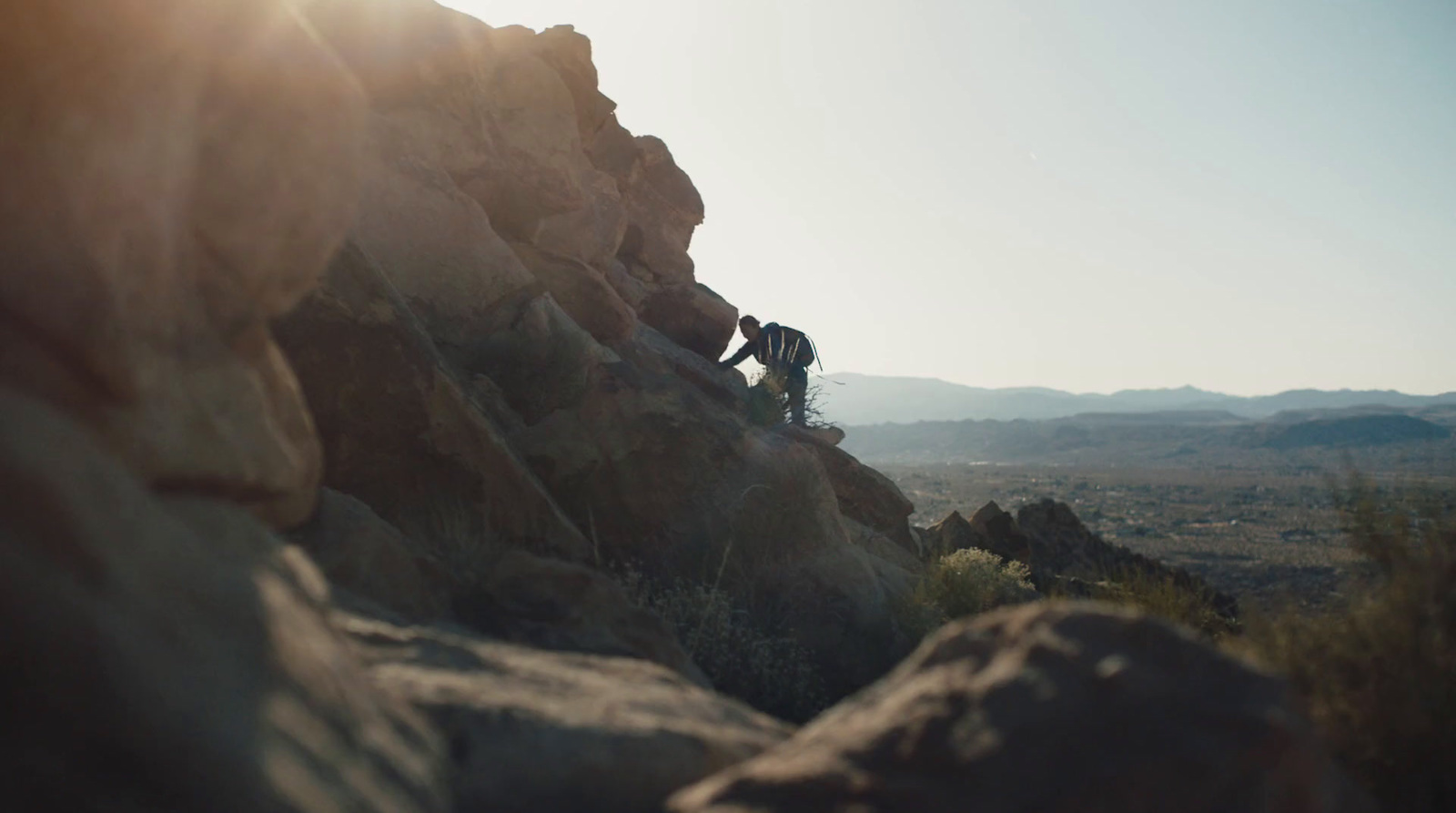 a man riding a bike down a rocky hillside