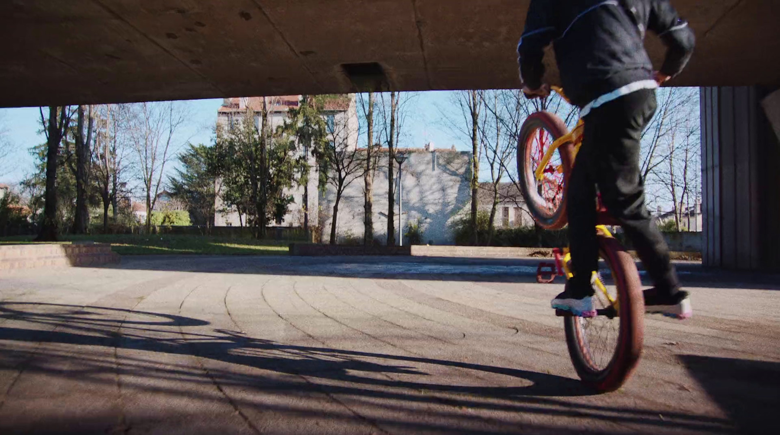 a person is riding a bike in a parking lot