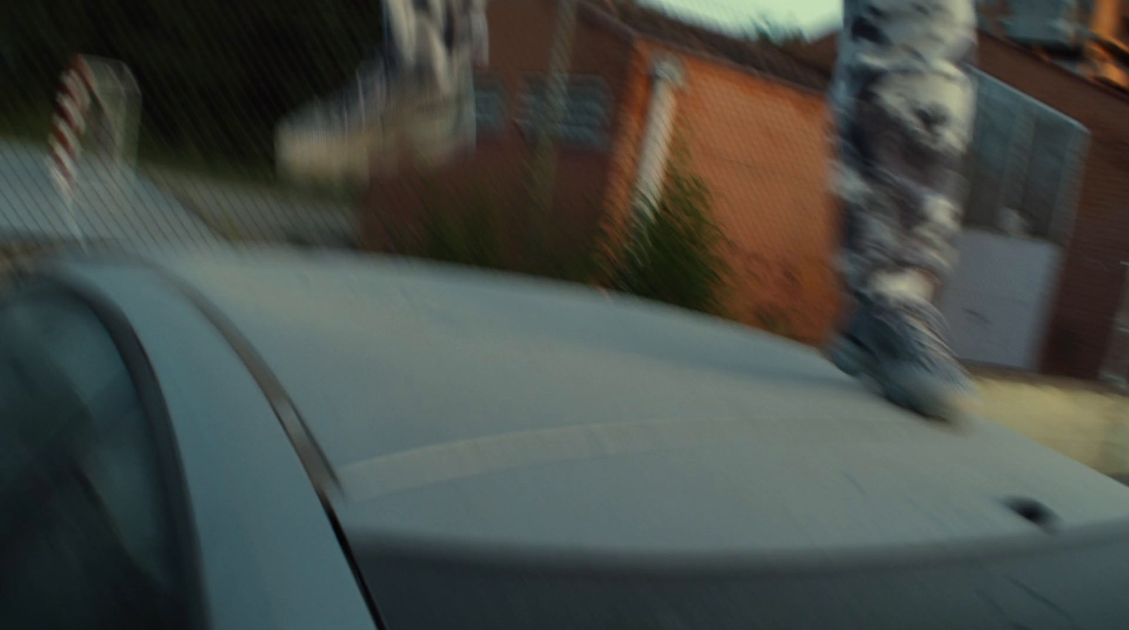 a person riding a skateboard on top of a car