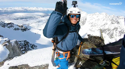 a man standing on top of a snow covered mountain