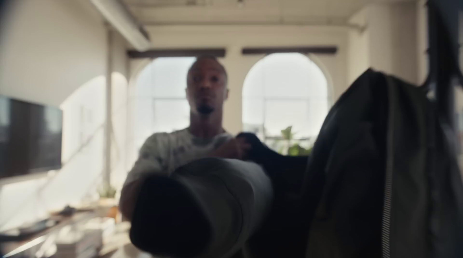 a man holding a black bag in a room