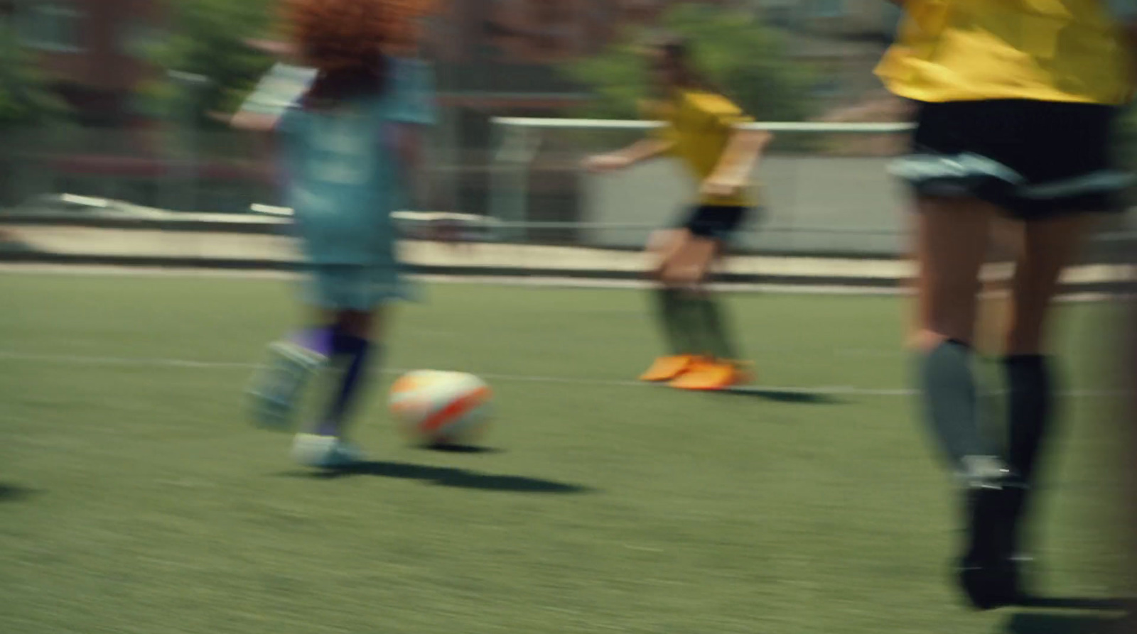 a blurry photo of two girls playing soccer