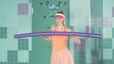 a woman in a pink dress holding a large blue object