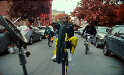 a group of people riding bikes down a street