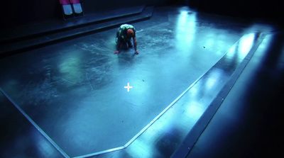 a person standing on a stage in a dark room