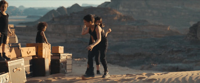 a group of people standing on top of a desert