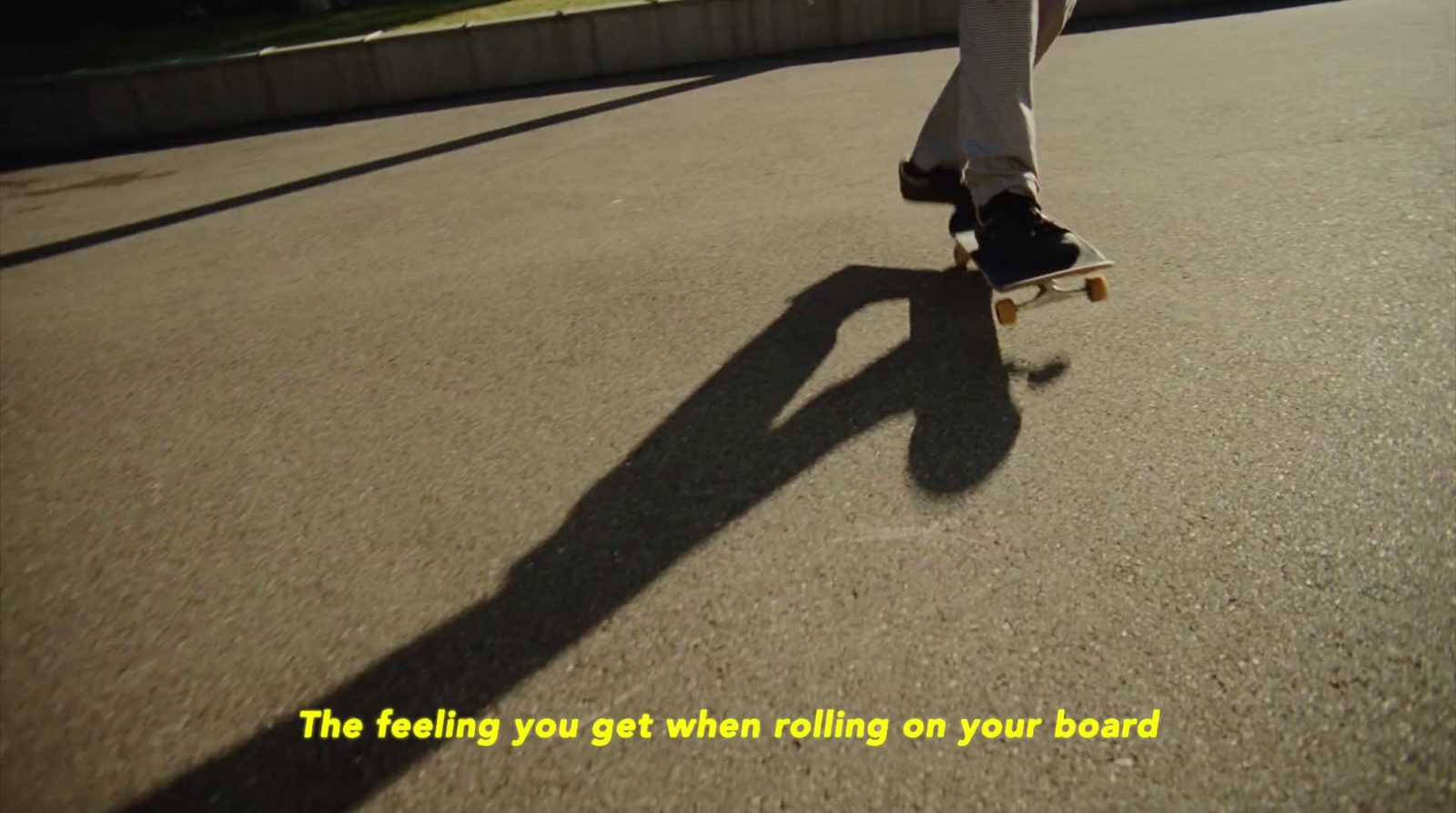 a person riding a skateboard down a street