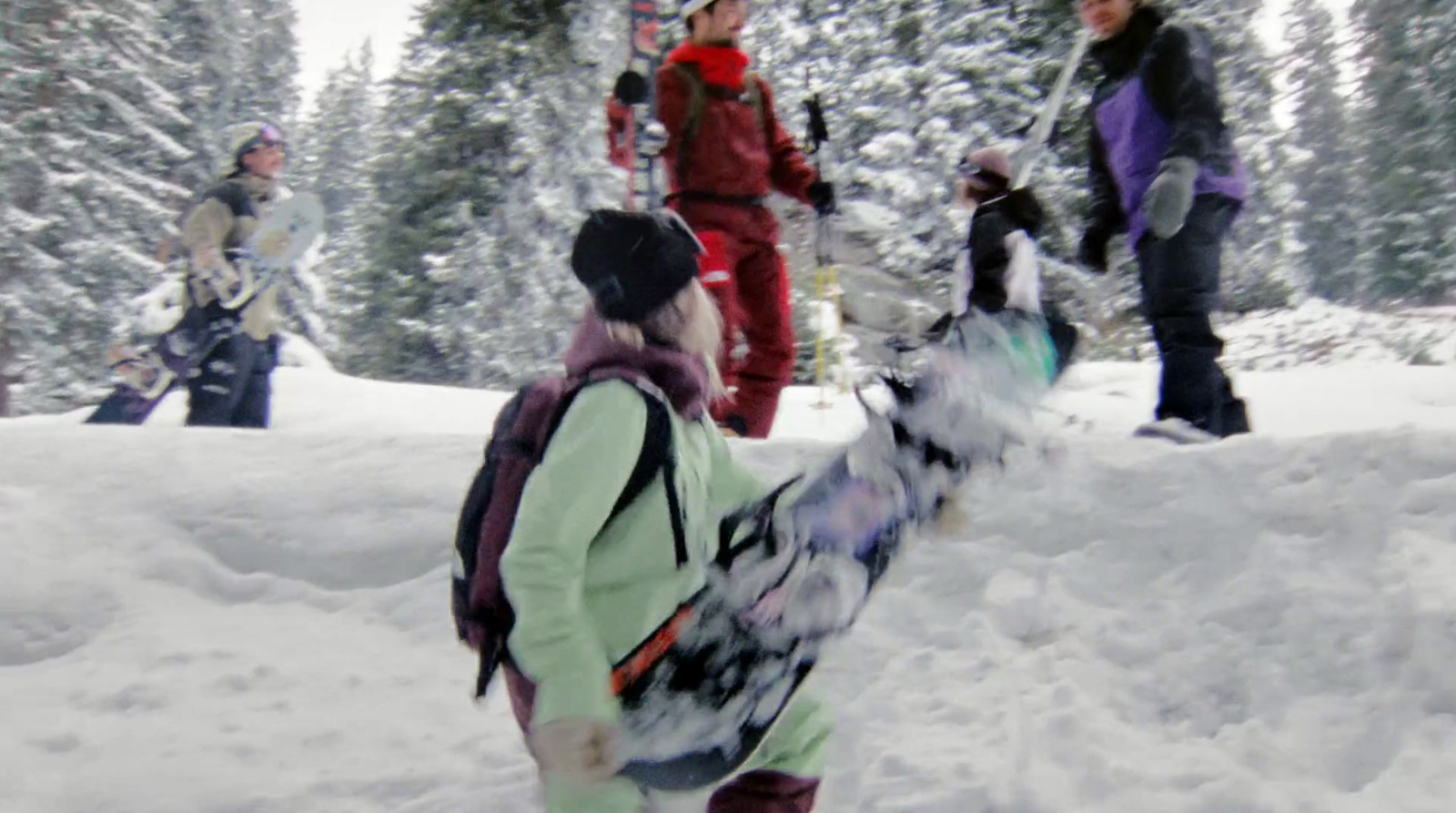 a group of people standing on top of a snow covered slope