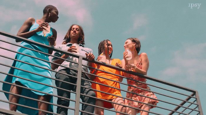 a group of people standing on top of a metal railing