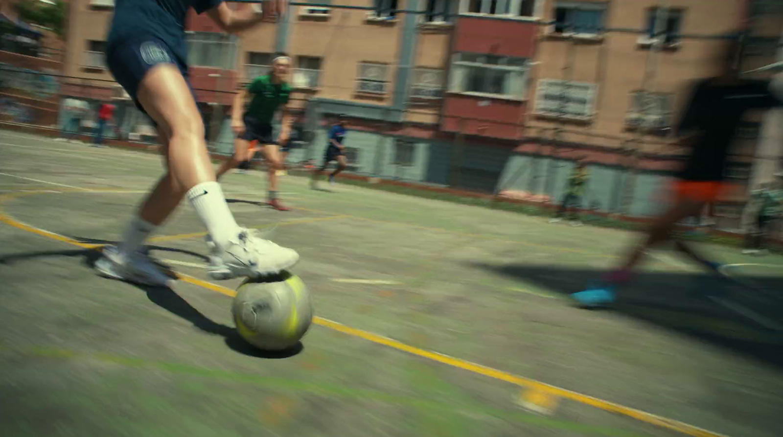 a person kicking a soccer ball on a court