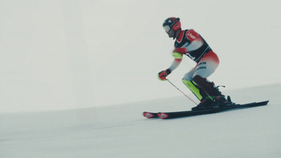 a man riding skis down a snow covered slope