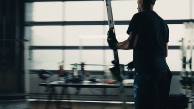 a man holding a baseball bat in a room