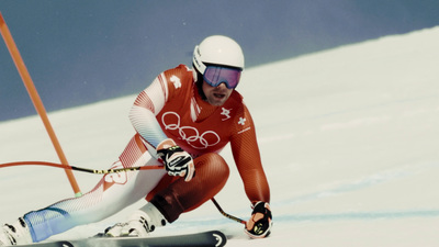 a man riding skis down a snow covered slope