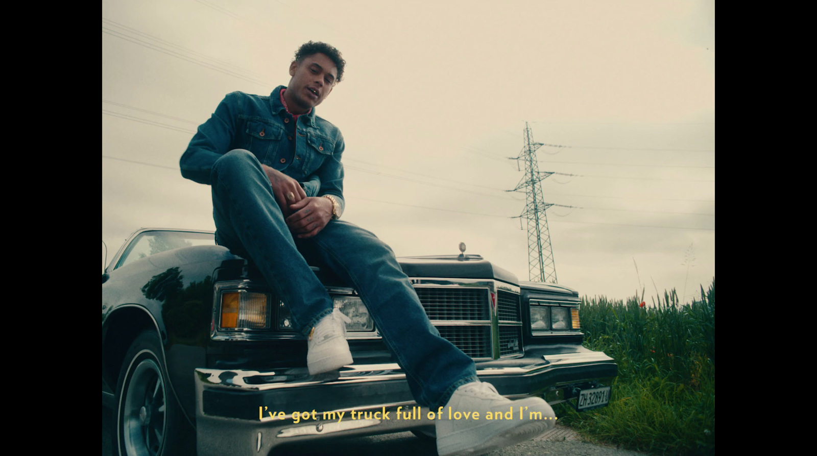 a man sitting on the hood of a truck