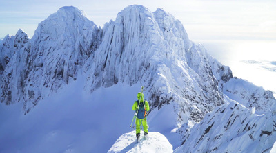 a man standing on top of a snow covered mountain