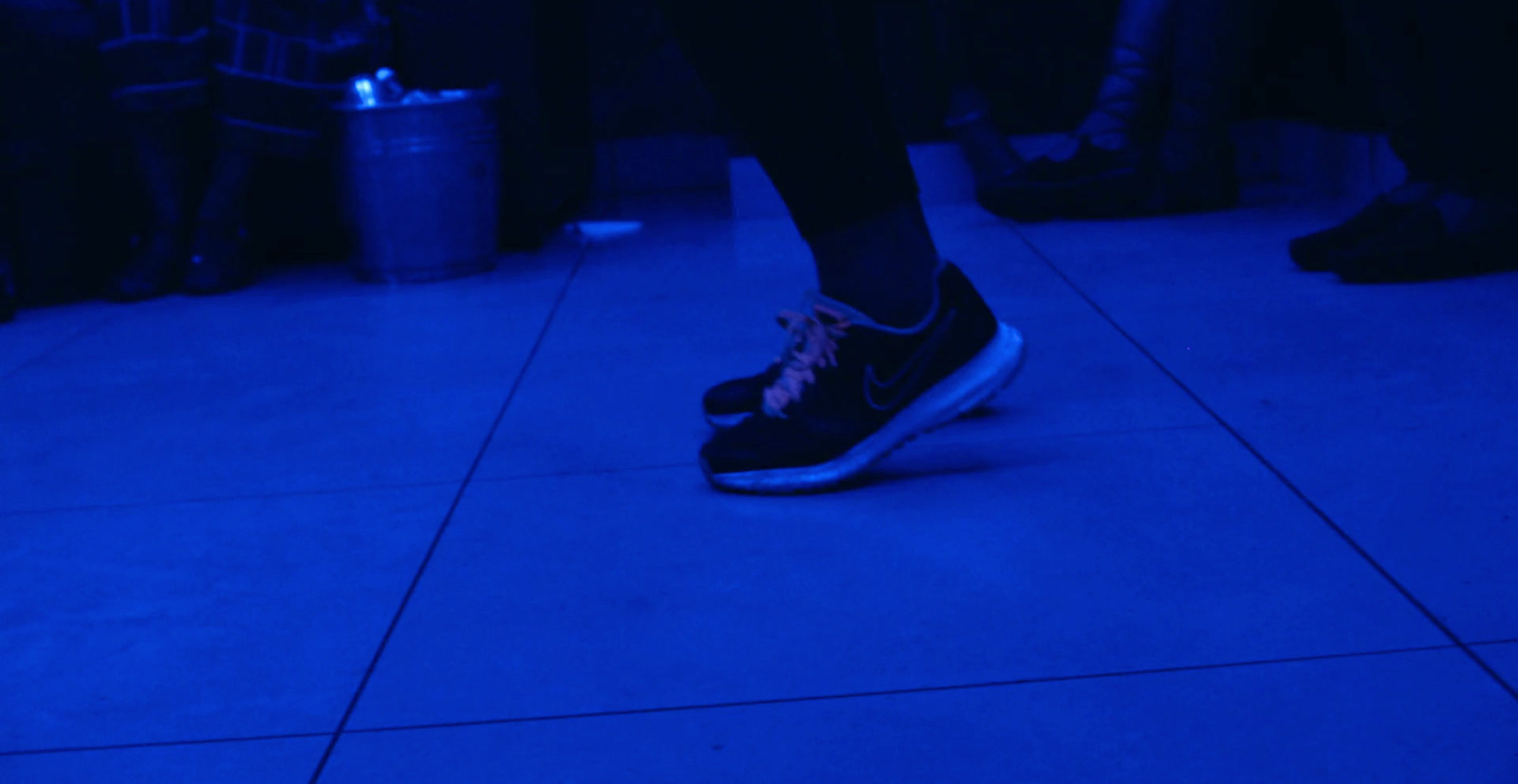 a person standing on a blue lit floor