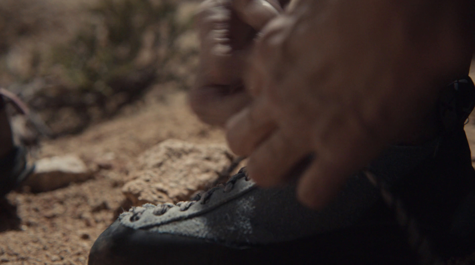 a close up of a person tying a shoelace