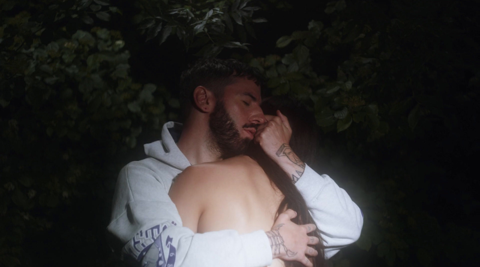 a man with a beard is hugging a woman