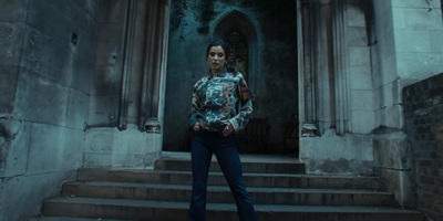 a woman standing in front of a doorway