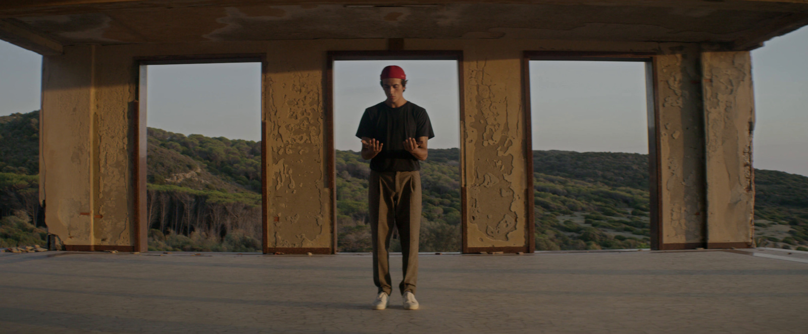 a man standing in front of a wooden structure