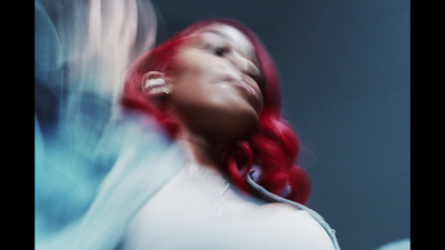 a woman with red hair and a white shirt