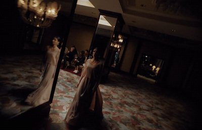 a couple of women standing in front of a mirror