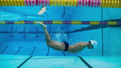 a man swimming in a pool under water