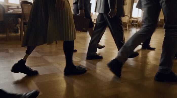 a group of people standing on top of a hard wood floor