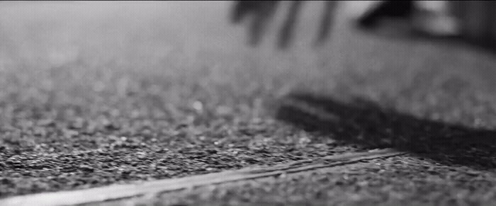 a black and white photo of a bench and grass