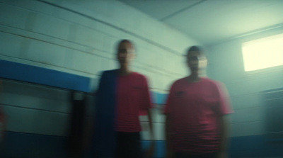 a blurry photo of two men in red shirts