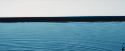 a white boat floating on top of a body of water