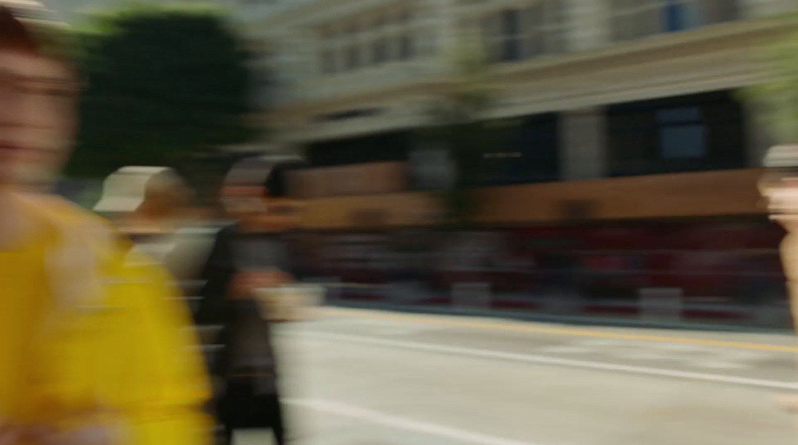 a blurry photo of a woman walking down the street