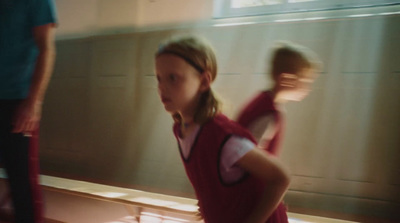 a young girl standing in front of a mirror