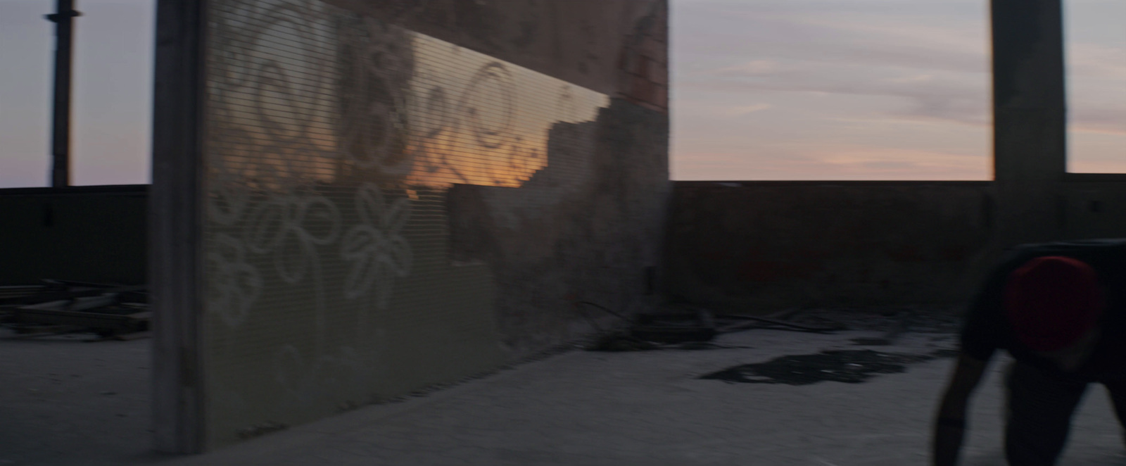 a person standing in front of a wall with graffiti on it