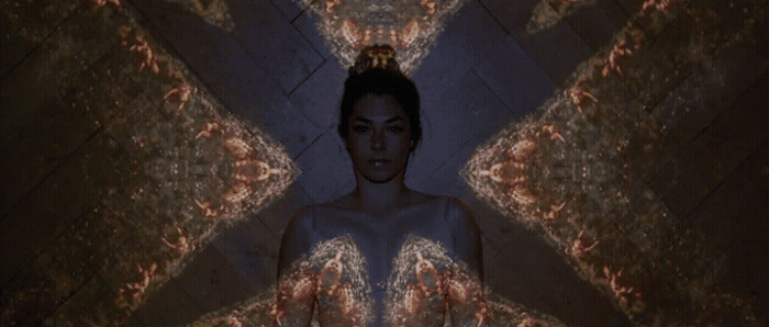 a woman standing in front of a mirror in a room