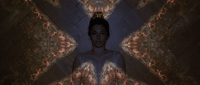 a woman standing in front of a mirror in a room