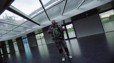 a man standing in a large room with lots of windows