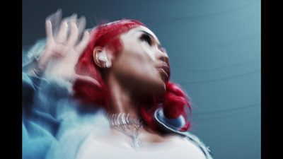 a woman with red hair and piercings on her ear