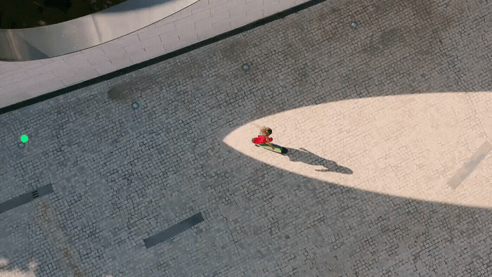 an aerial view of a person walking down a sidewalk