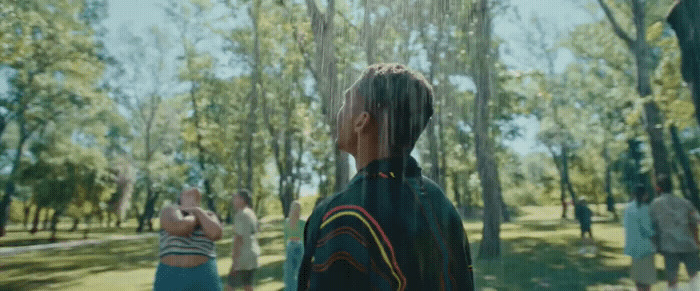 a woman standing in the middle of a park