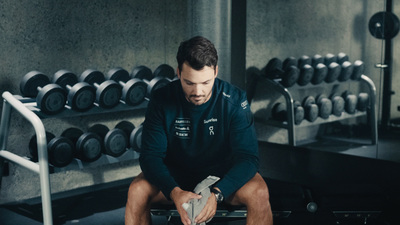 a man sitting on a bench in a gym