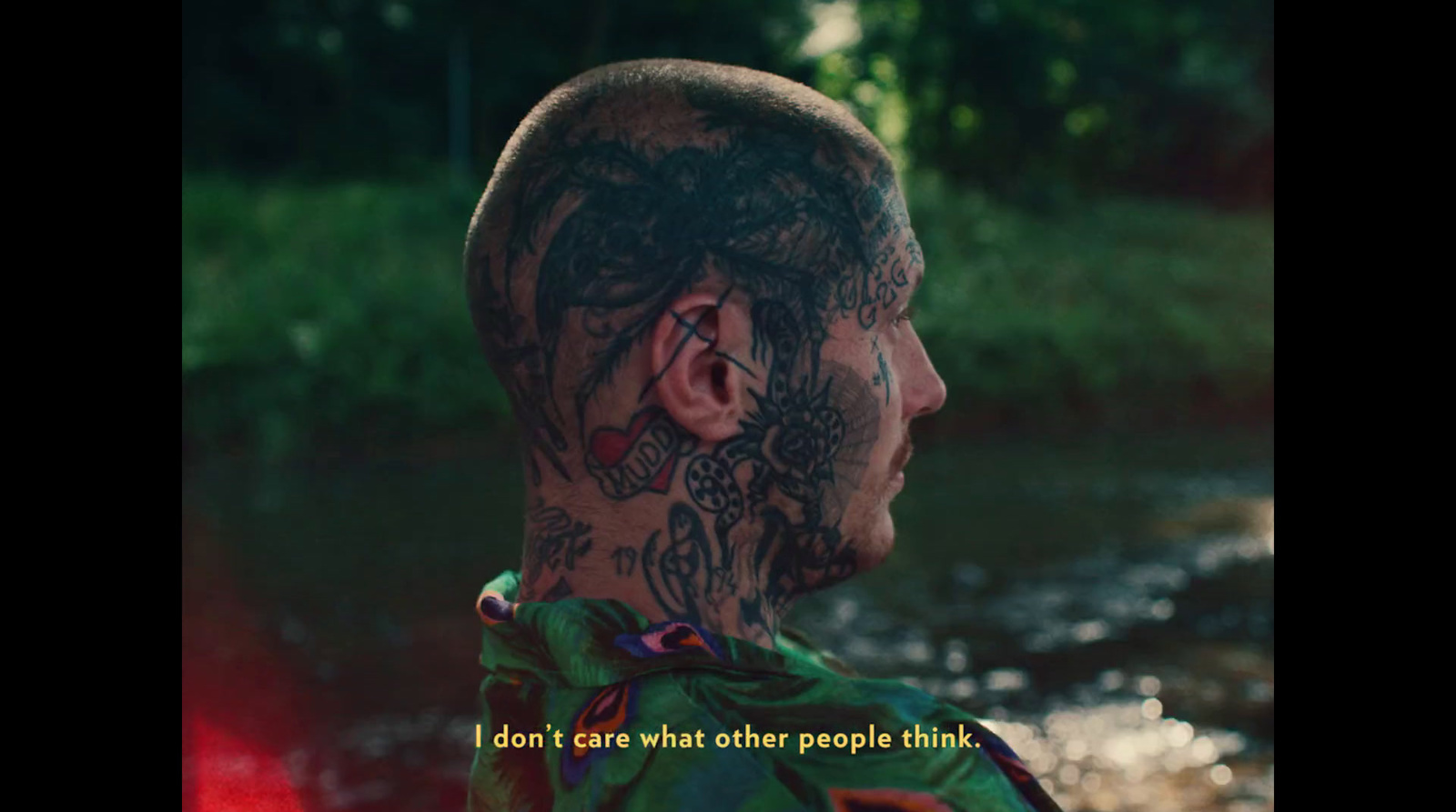 a man with tattoos on his face and neck