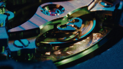 a close up of a clock with a blue background