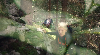 a blurry photo of a woman in the woods