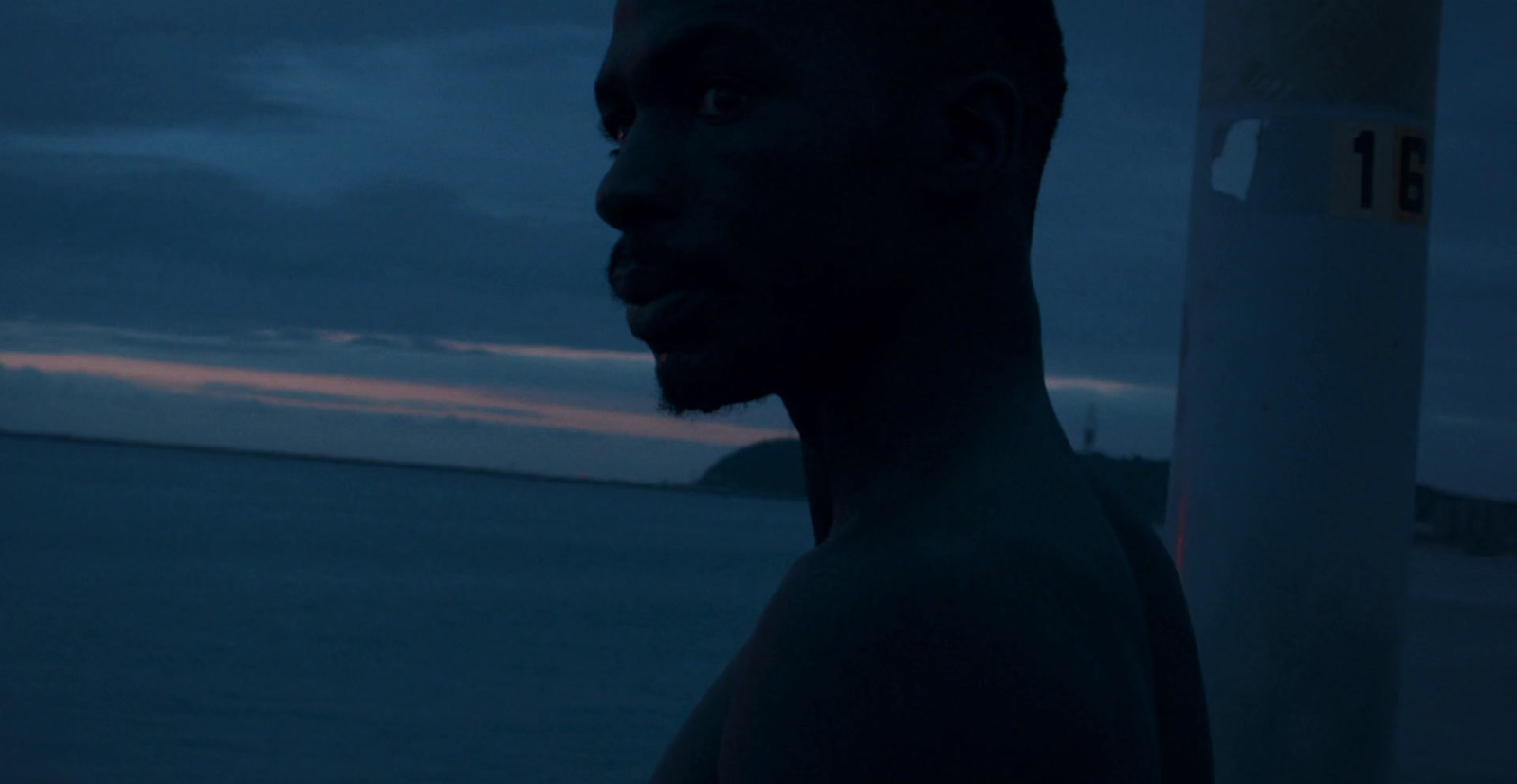 a man standing in front of a body of water