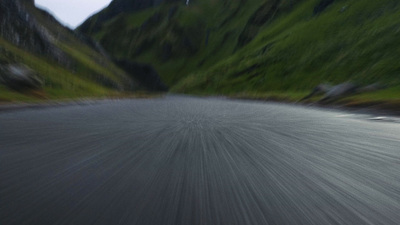 a person riding a skateboard down a curvy road