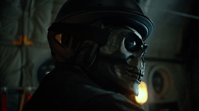 a skeleton wearing a helmet in a dimly lit room