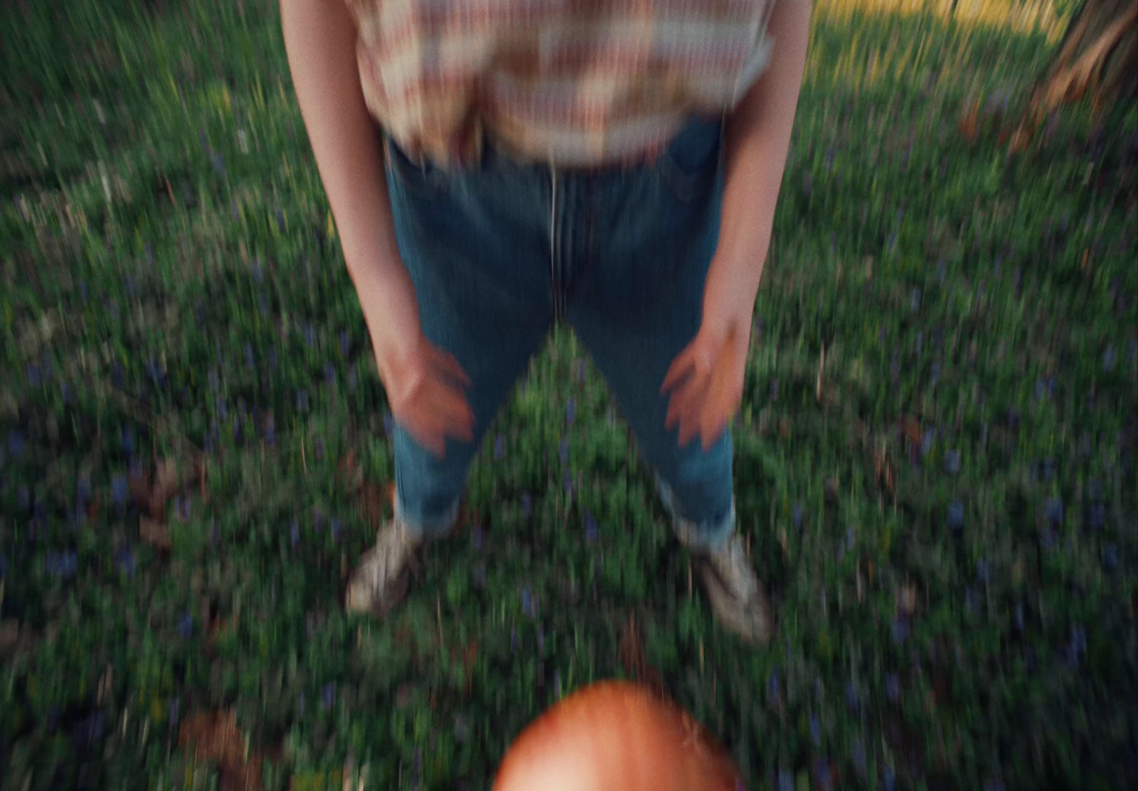 a person standing in a field with a frisbee