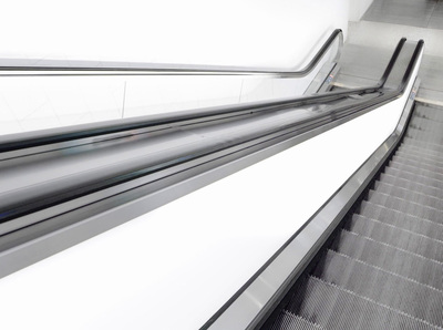 an escalator going down a set of stairs