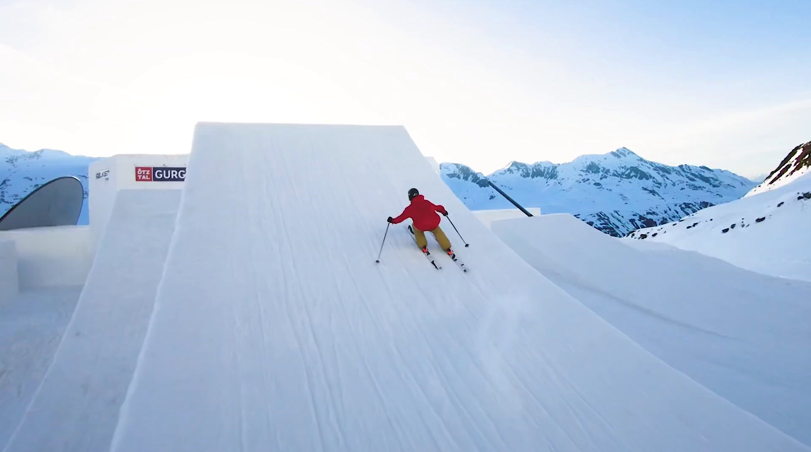 a person on skis going down a snowy slope